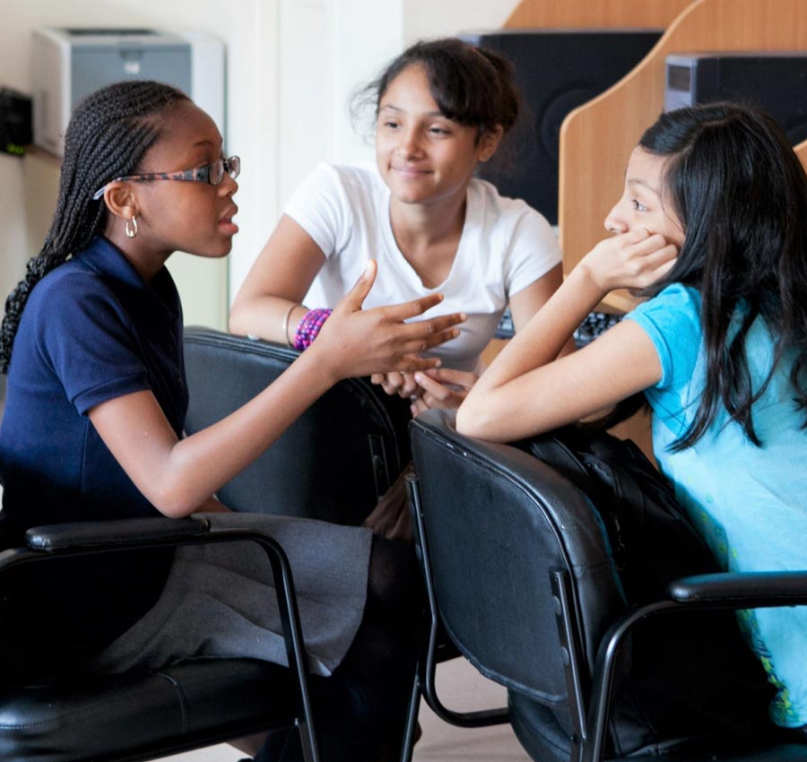 Group of young multicultural girls sitting and talking